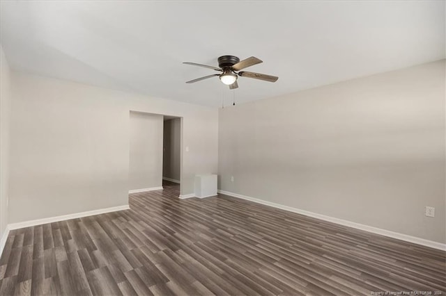 spare room featuring ceiling fan and dark wood-type flooring