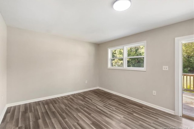 spare room featuring dark hardwood / wood-style floors