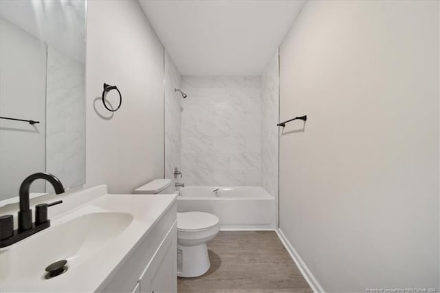 full bathroom featuring wood-type flooring, vanity, toilet, and tiled shower / bath