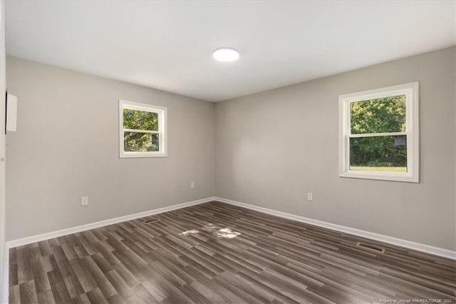 unfurnished room featuring dark wood-type flooring