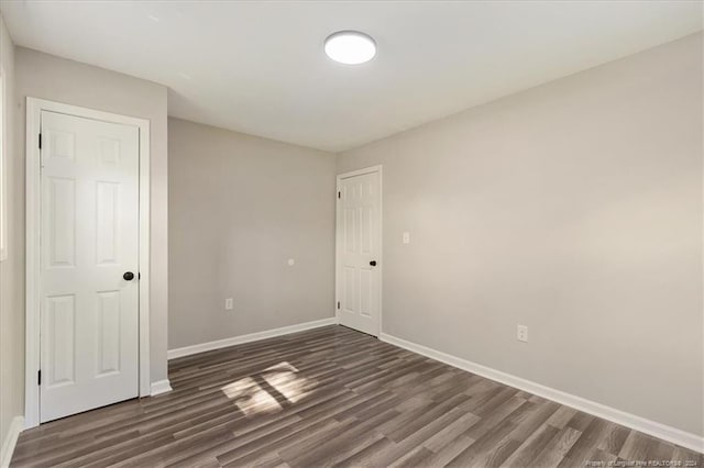 empty room with dark wood-type flooring