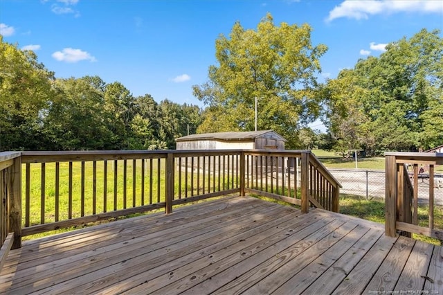 deck with a lawn and a shed