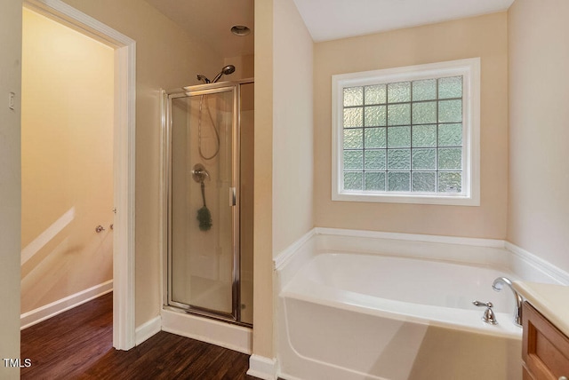 bathroom featuring vanity, hardwood / wood-style floors, and independent shower and bath