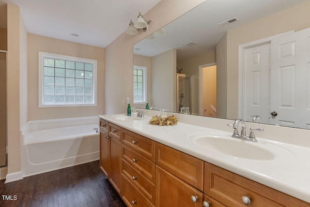 full bathroom featuring vanity, hardwood / wood-style floors, toilet, and separate shower and tub