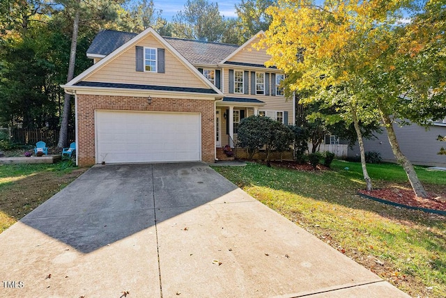 65 Applegate Dr, Franklinton, NC 27525 - traditional-style home featuring concrete driveway, brick siding, and a front lawn