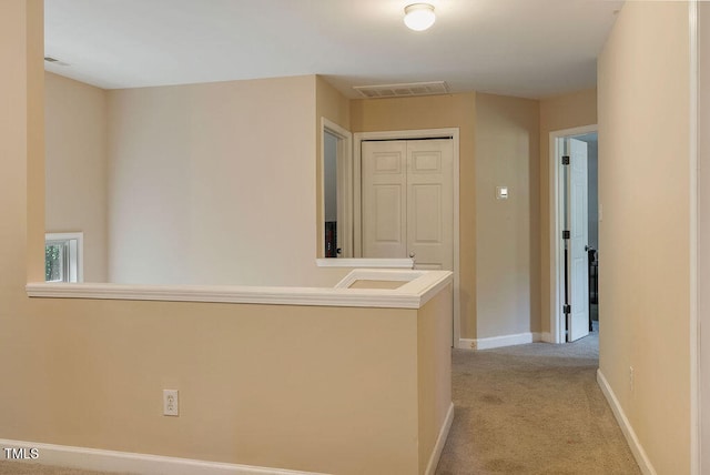 hallway featuring light carpet