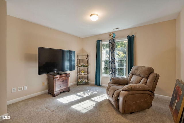 sitting room featuring light colored carpet