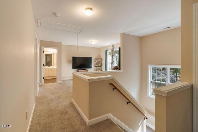 65 Applegate Dr, Franklinton, NC 27525 - corridor featuring a wealth of natural light, attic access, light colored carpet, and an upstairs landing