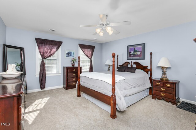 bedroom featuring light colored carpet and ceiling fan