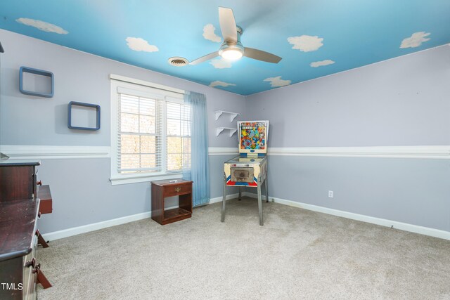 interior space with ceiling fan and light colored carpet