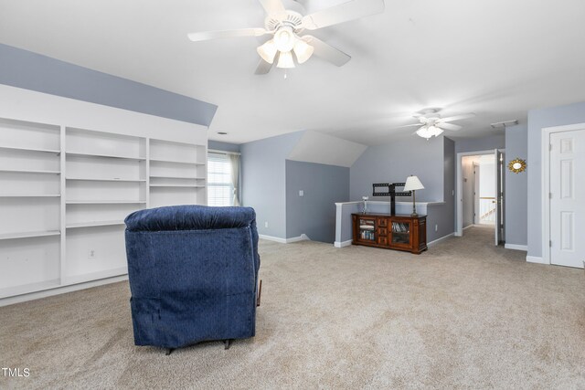 sitting room with ceiling fan and carpet