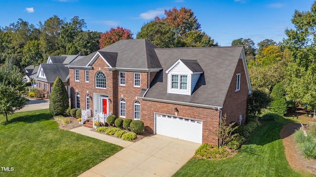 view of front of house with a front yard and a garage