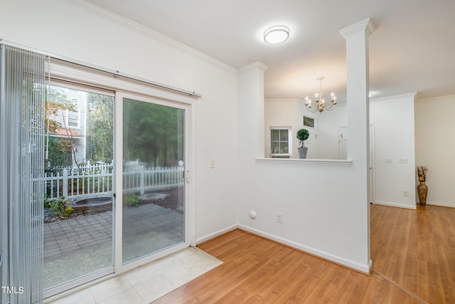 interior space featuring light hardwood / wood-style flooring, ornamental molding, and a chandelier