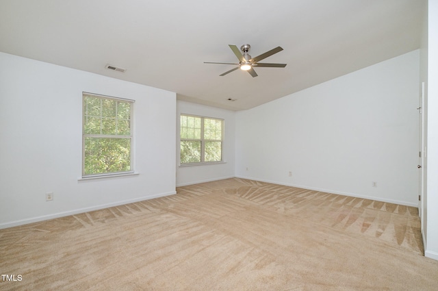 carpeted spare room featuring ceiling fan