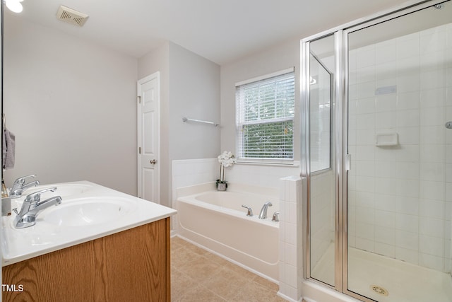 bathroom with vanity and shower with separate bathtub