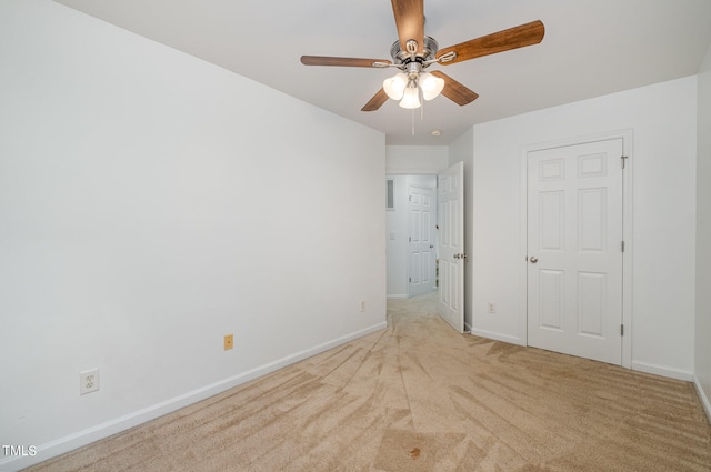 unfurnished bedroom featuring ceiling fan and light carpet