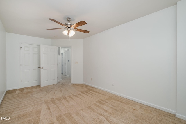 unfurnished bedroom with ceiling fan and light carpet