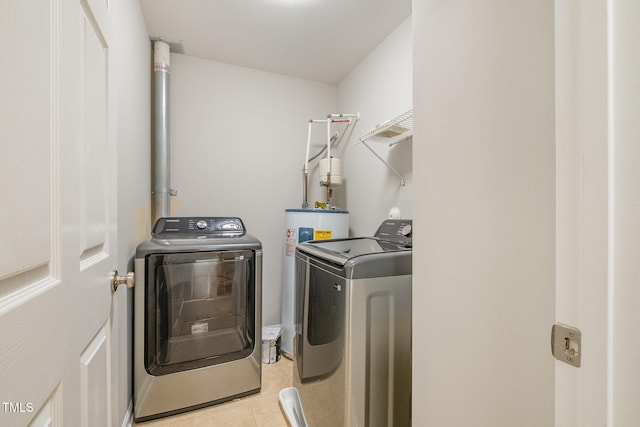 laundry room with independent washer and dryer, water heater, and light tile patterned flooring