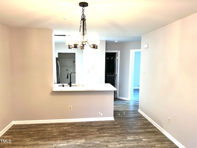 interior space featuring an inviting chandelier, dark wood-type flooring, and sink