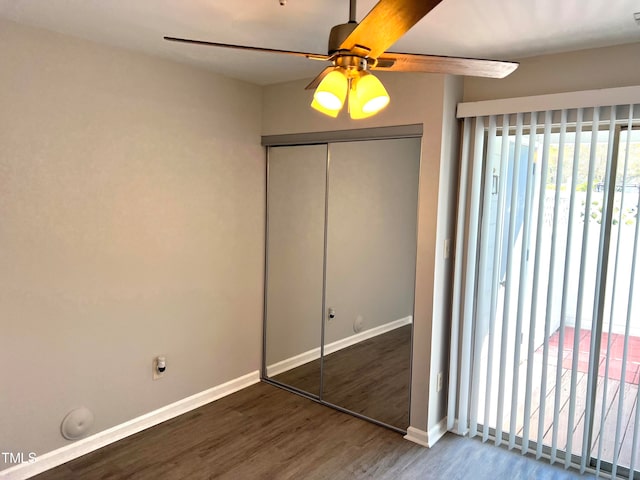 unfurnished bedroom with ceiling fan, a closet, and dark hardwood / wood-style floors