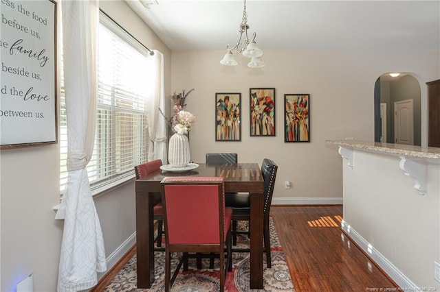 dining room featuring a chandelier and dark hardwood / wood-style floors