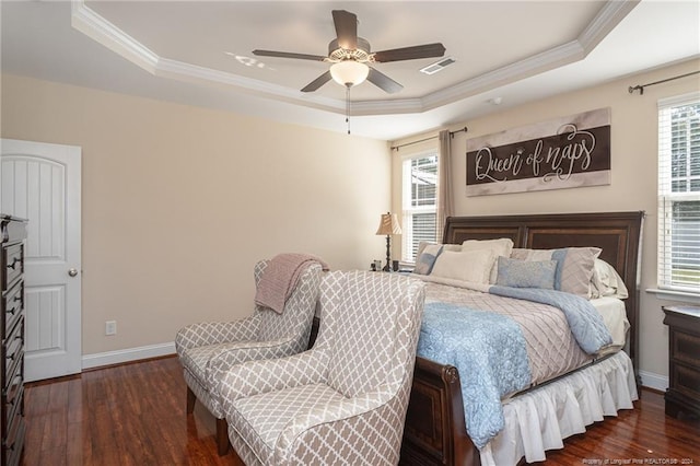 bedroom featuring ceiling fan, a tray ceiling, dark hardwood / wood-style flooring, and multiple windows