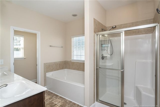 bathroom featuring plenty of natural light, vanity, and shower with separate bathtub