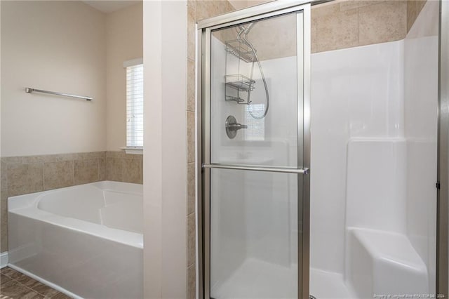 bathroom with separate shower and tub