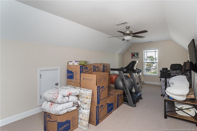 interior space featuring ceiling fan, light colored carpet, and vaulted ceiling