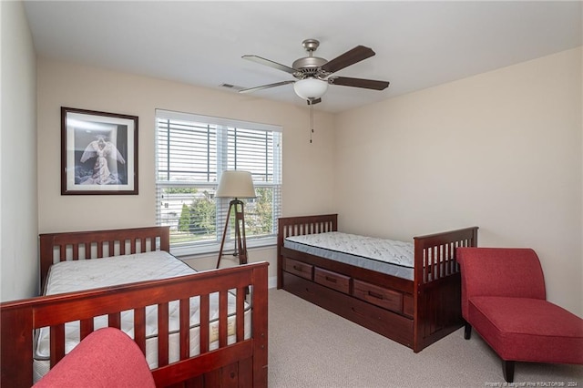 bedroom with ceiling fan and light colored carpet