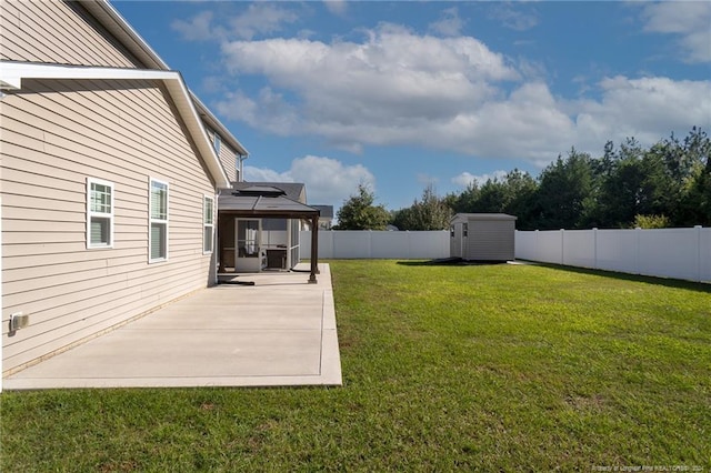 view of yard featuring a gazebo, a storage unit, and a patio area