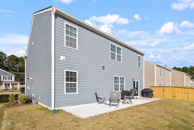 back of house featuring a patio area, central AC, and a yard