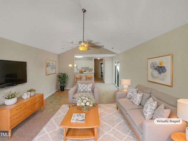 carpeted living room with ceiling fan and vaulted ceiling