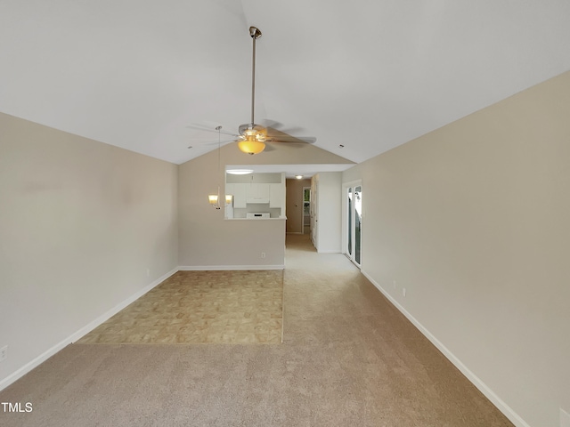 unfurnished living room featuring lofted ceiling, ceiling fan, and light carpet