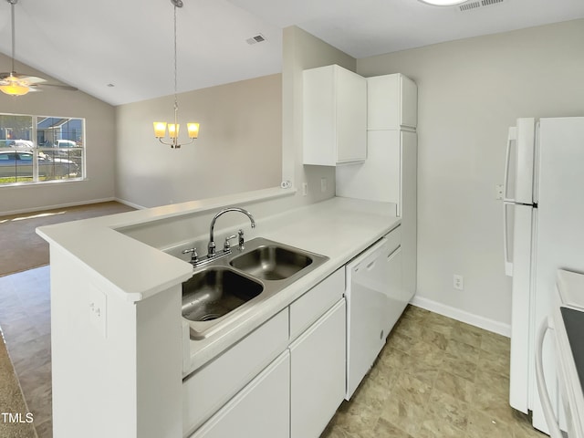 kitchen with white appliances, kitchen peninsula, white cabinetry, vaulted ceiling, and decorative light fixtures