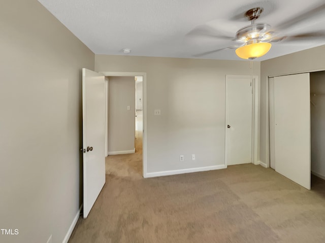 unfurnished bedroom with light carpet and ceiling fan