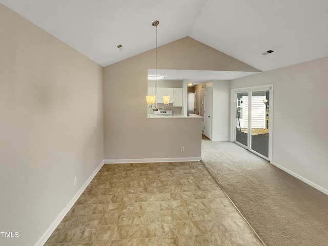 carpeted spare room with an inviting chandelier and vaulted ceiling