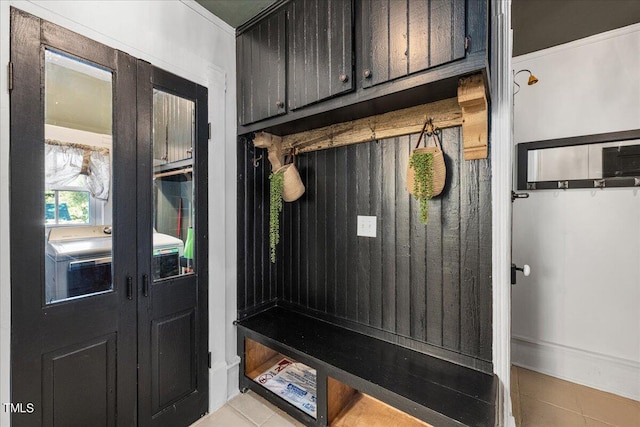 mudroom featuring ornamental molding and light tile patterned floors