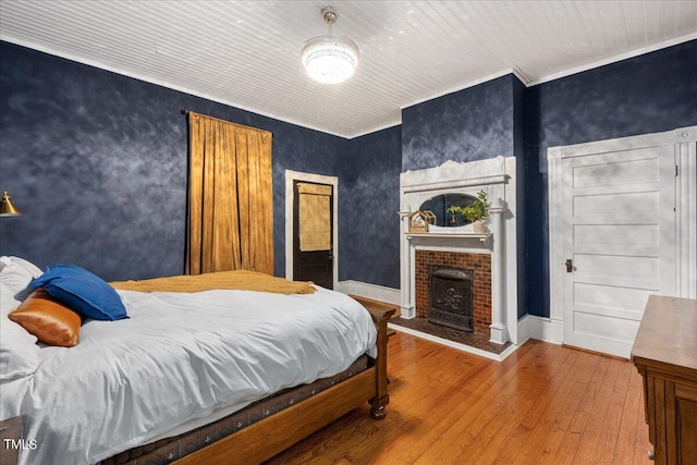 bedroom featuring crown molding and hardwood / wood-style floors