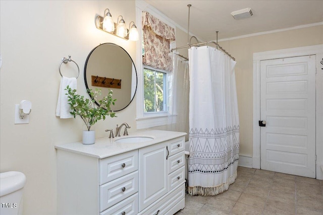 bathroom featuring walk in shower, crown molding, vanity, and toilet