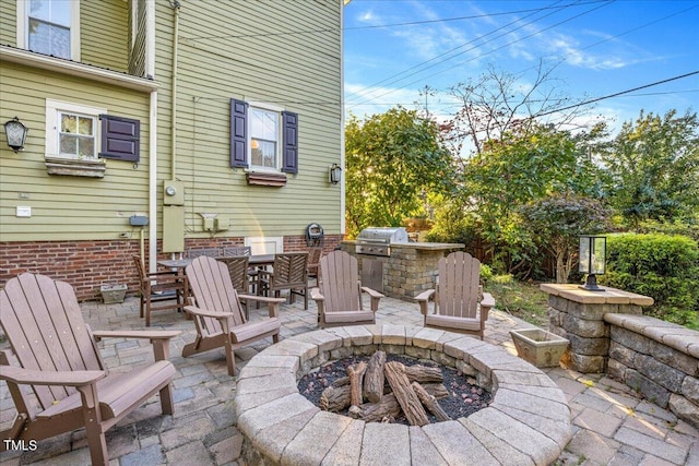 view of patio / terrace with a fire pit and grilling area