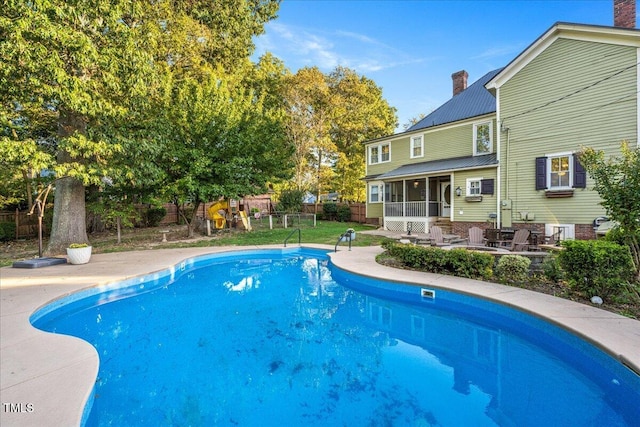 view of swimming pool with a patio