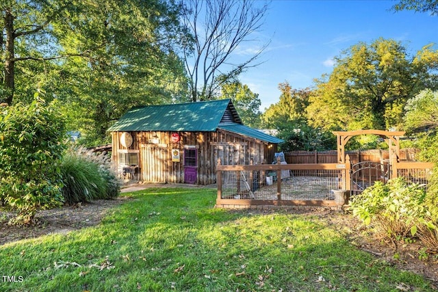 view of outbuilding with a yard