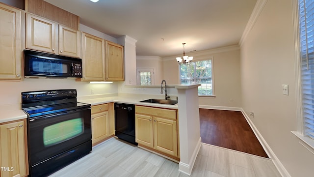 kitchen with light wood-type flooring, black appliances, sink, hanging light fixtures, and a chandelier