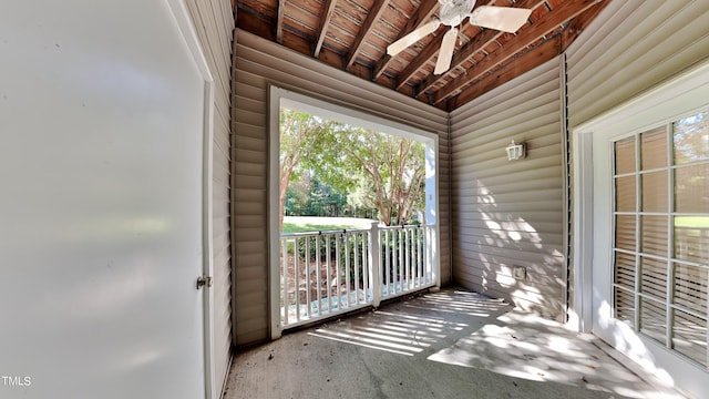 exterior space with beamed ceiling, ceiling fan, and wood ceiling