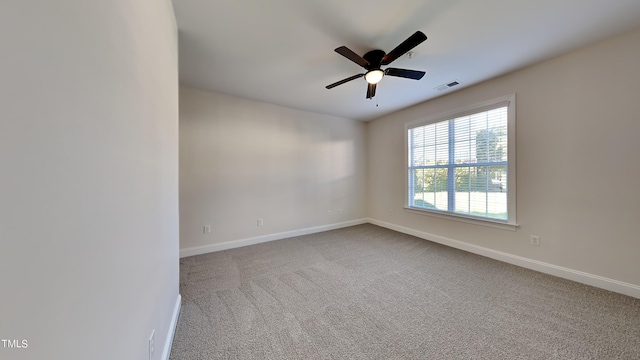 empty room with ceiling fan and carpet flooring