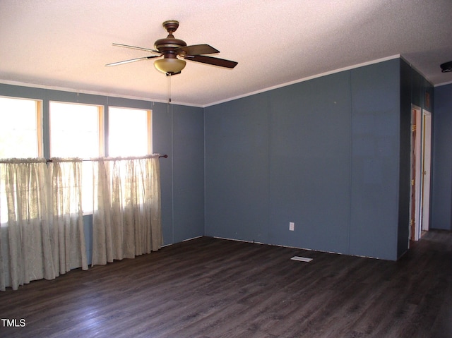 unfurnished room featuring ornamental molding, dark hardwood / wood-style floors, a textured ceiling, and ceiling fan