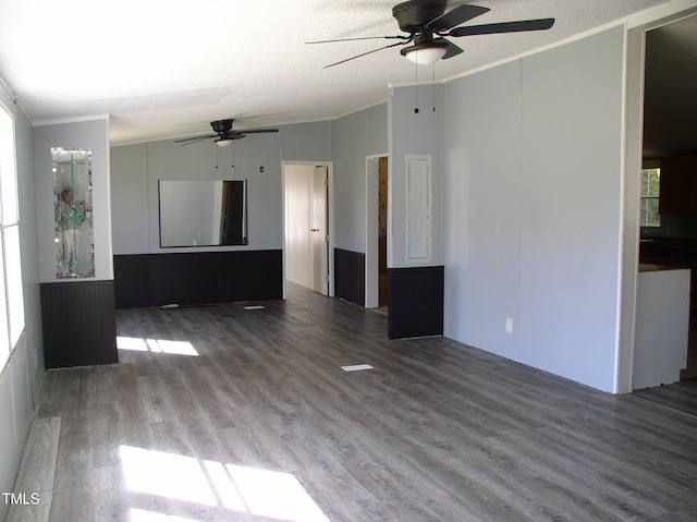 unfurnished living room featuring ceiling fan, ornamental molding, a textured ceiling, and hardwood / wood-style floors