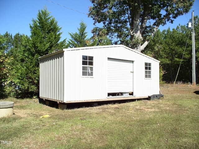 view of outbuilding featuring a yard