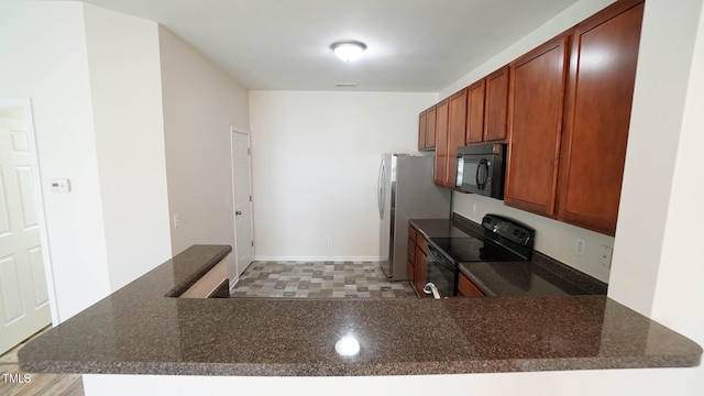 kitchen featuring kitchen peninsula and black appliances